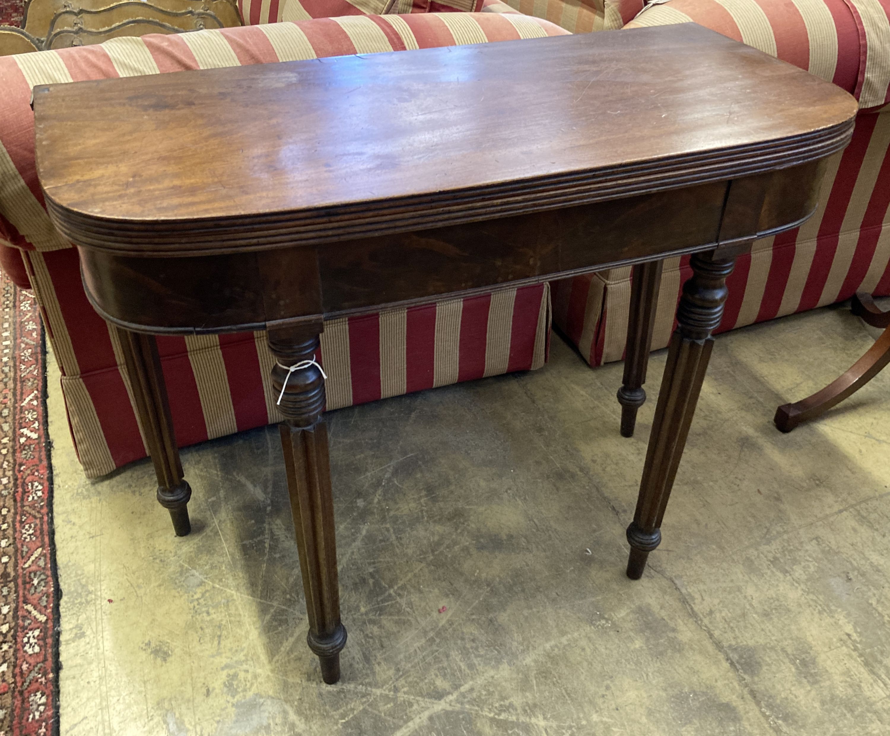 A Regency D shape mahogany folding tea table, width 93cm, depth 45cm, height 74cm